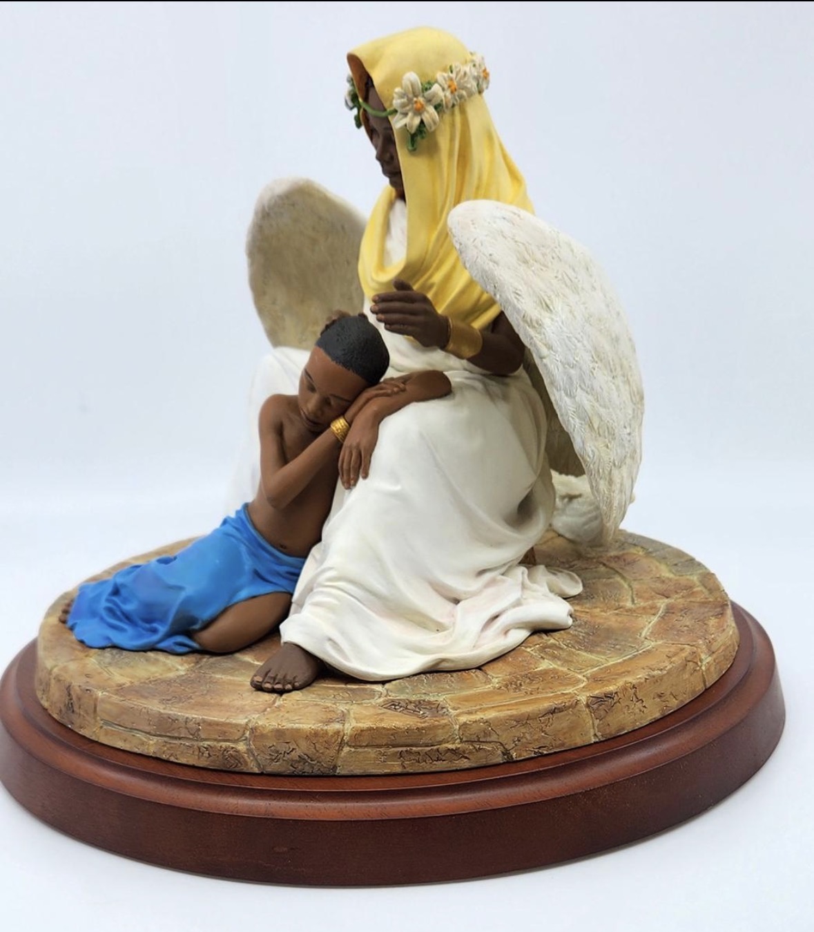 Angel with resting child, side view