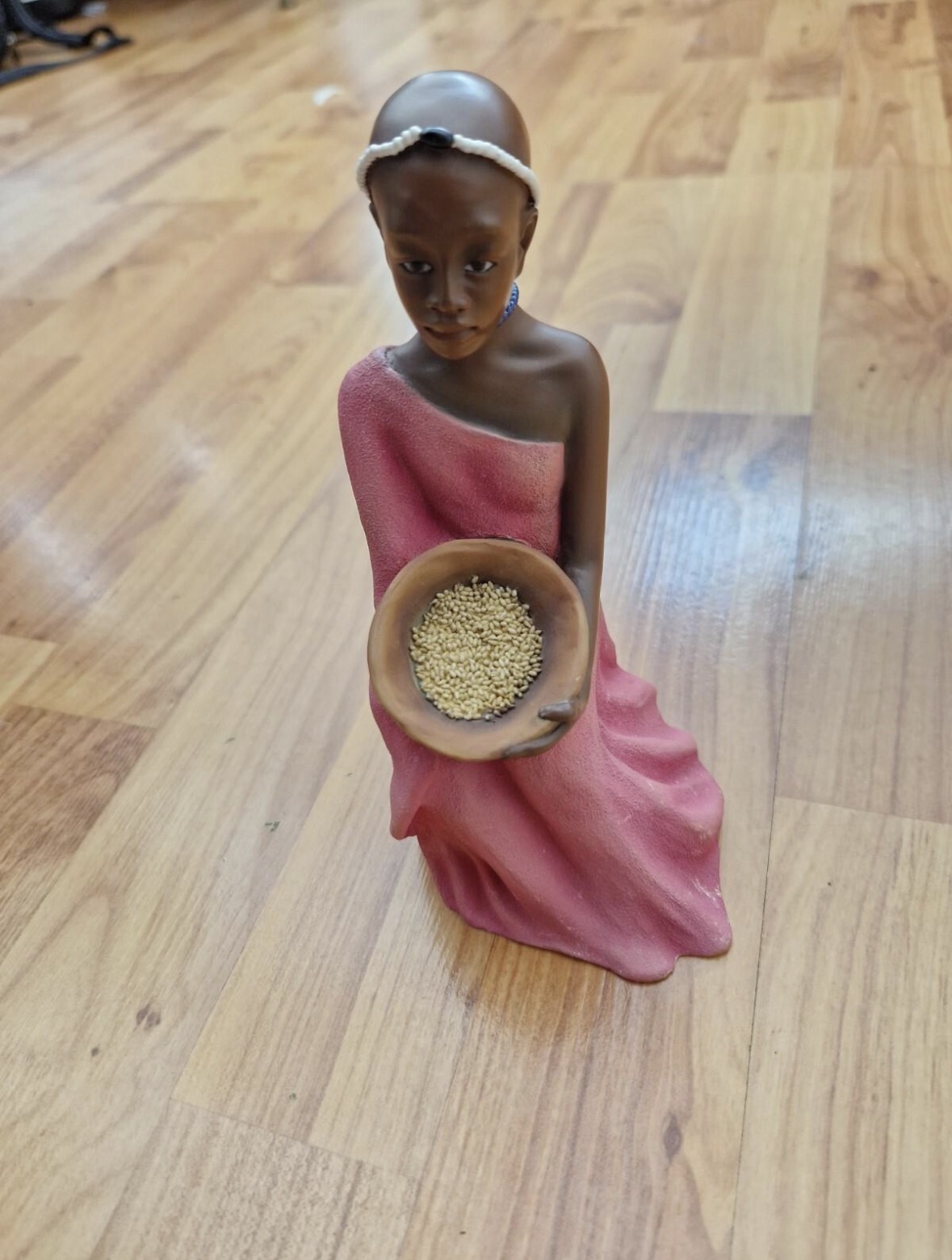 Kneeling girl with offering bowl